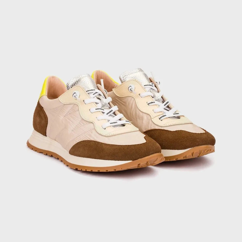 Pair of beige and brown sneakers on a white background