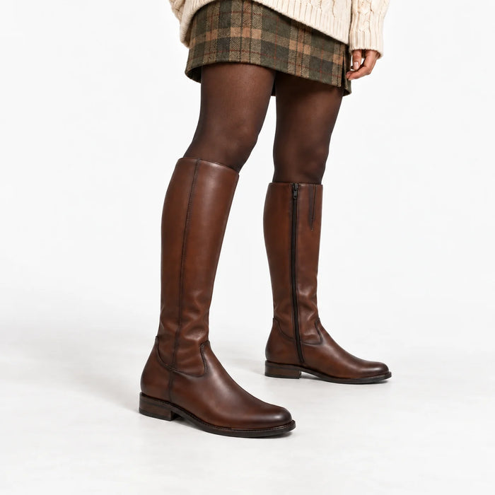 Dubarry Cadence chestnut knee-high boots styled with a checked skirt and cream knit