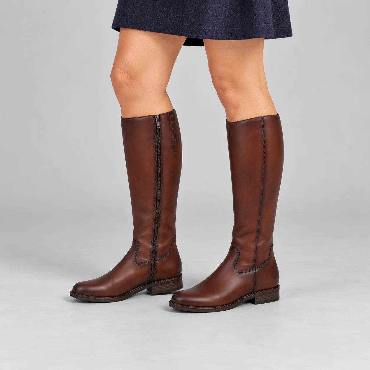 Dubarry Cadence Chestnut Leather Knee-High Boots worn by a female model, showing the snug calf fit and inside zip in a grey studio