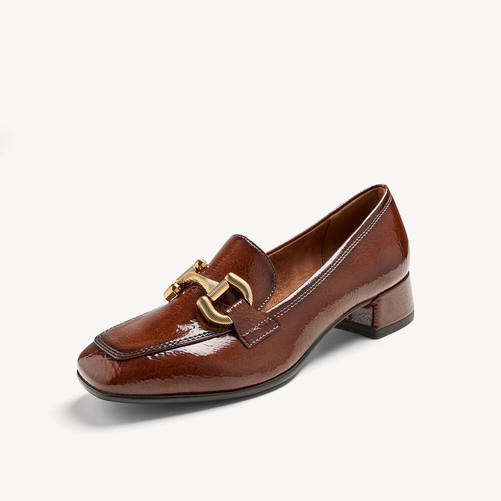 Brown leather loafer with gold buckle on a white background