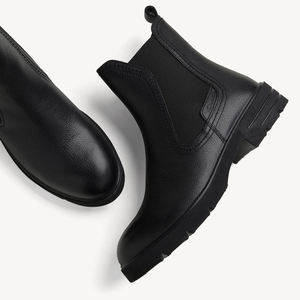 Pair of black Chelsea boots on a white background