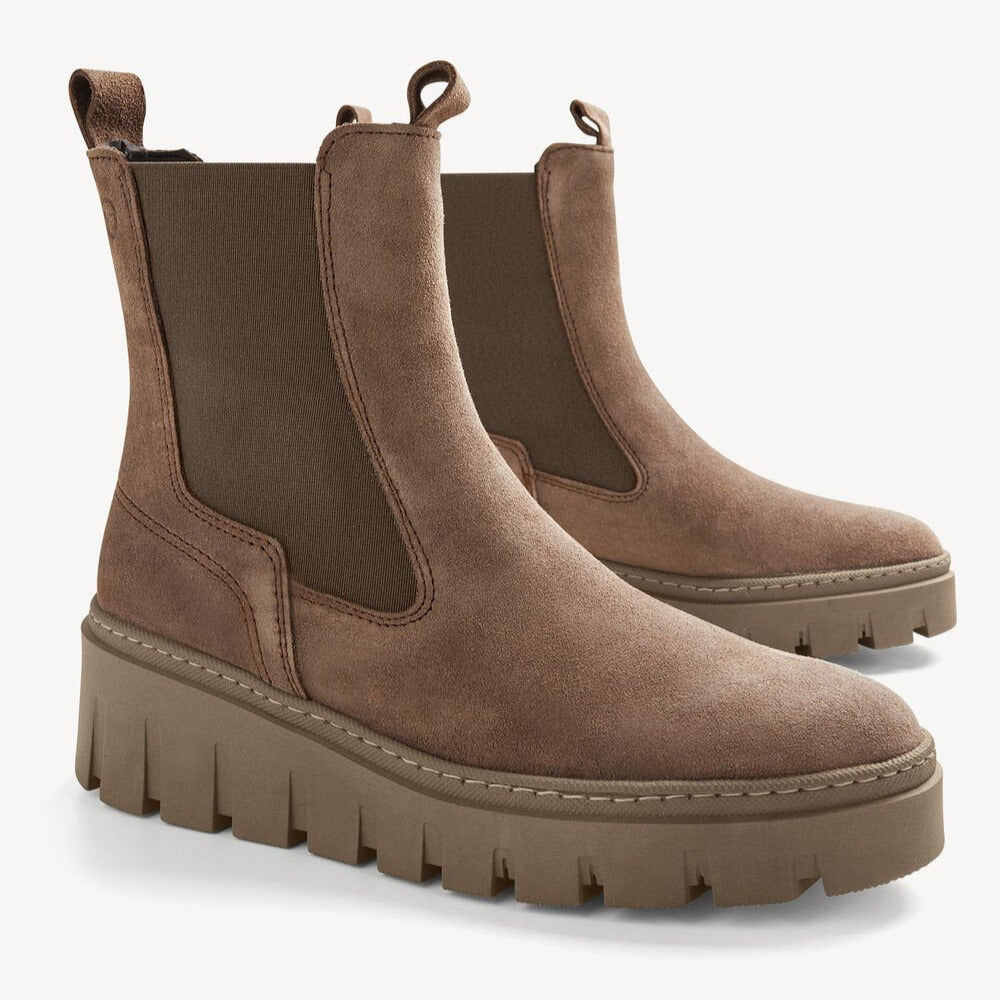 Pair of brown suede platform boots on a white background