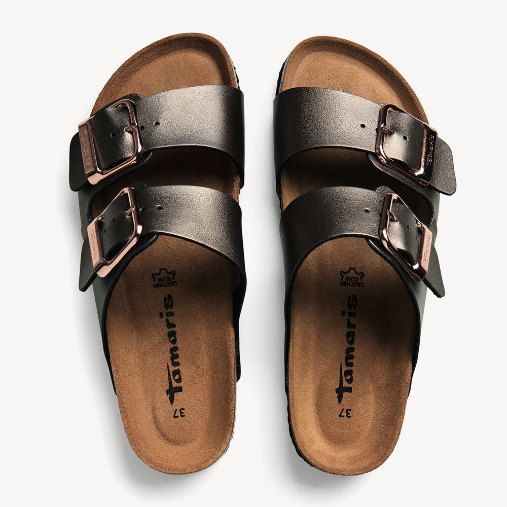 Pair of metallic sandals with brown soles on a white background