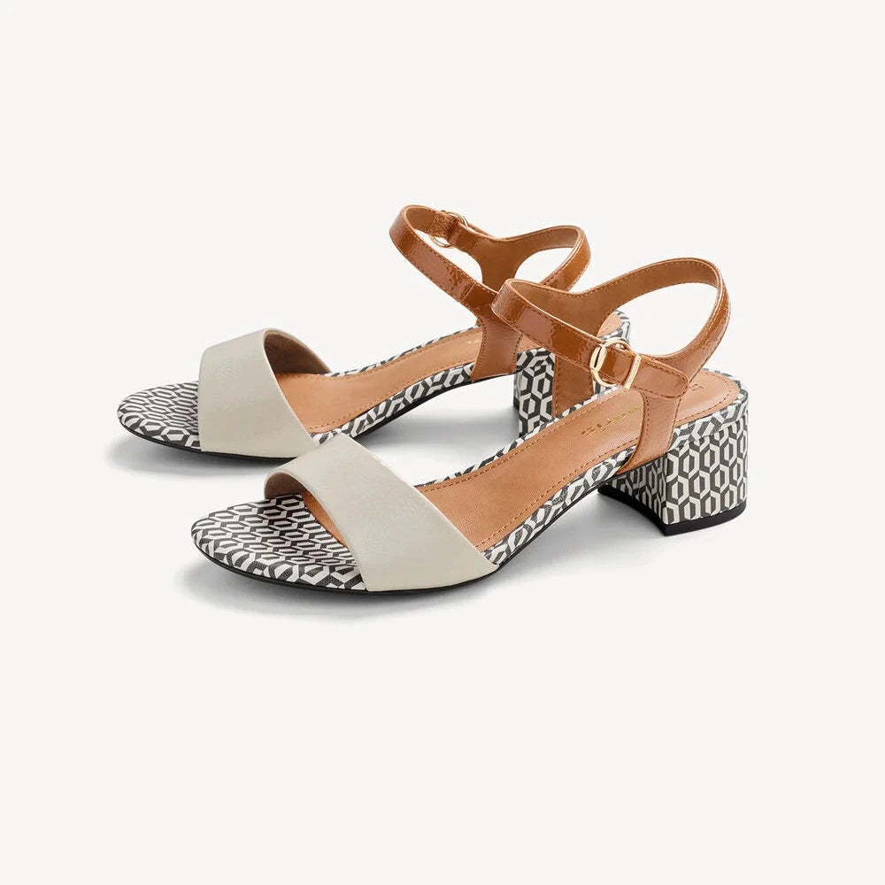 Pair of sandals with beige straps and patterned soles on a white background
