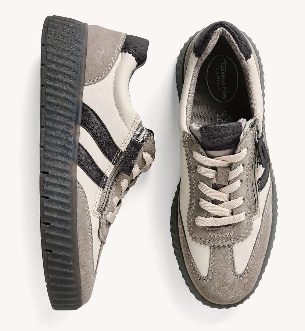 A pair of low-top platform sneakers shown from the side and top views on a light gray background. The shoes feature a taupe suede and cream mesh upper with black side stripes, a black zipper, and a chunky dark gray platform sole.