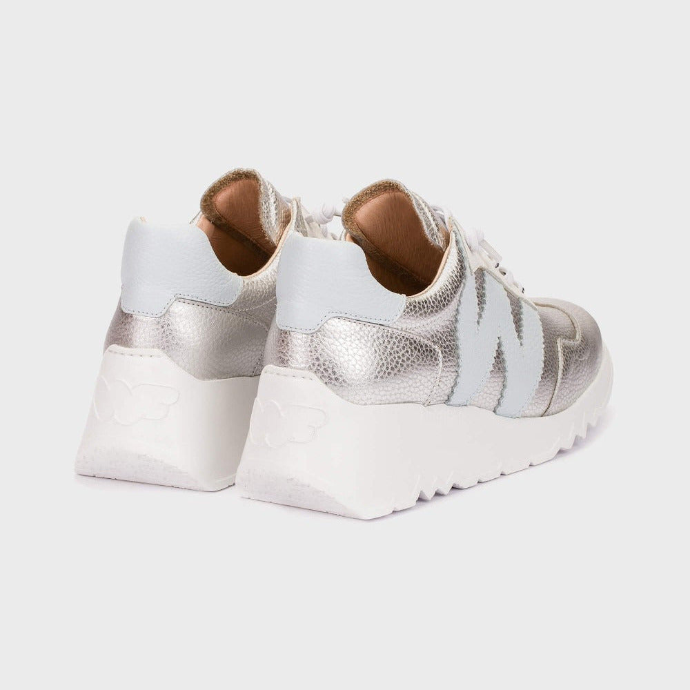 White sneakers with metallic accents on a light gray background