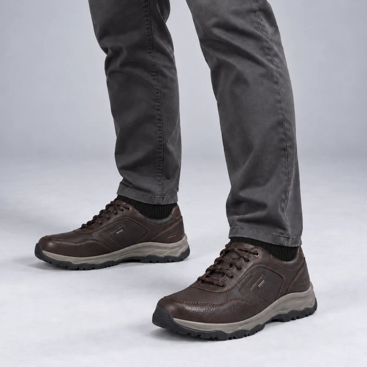 Male model wearing socks and Josef Seibel Leroy 60 in Moro Brown, square studio footwear view