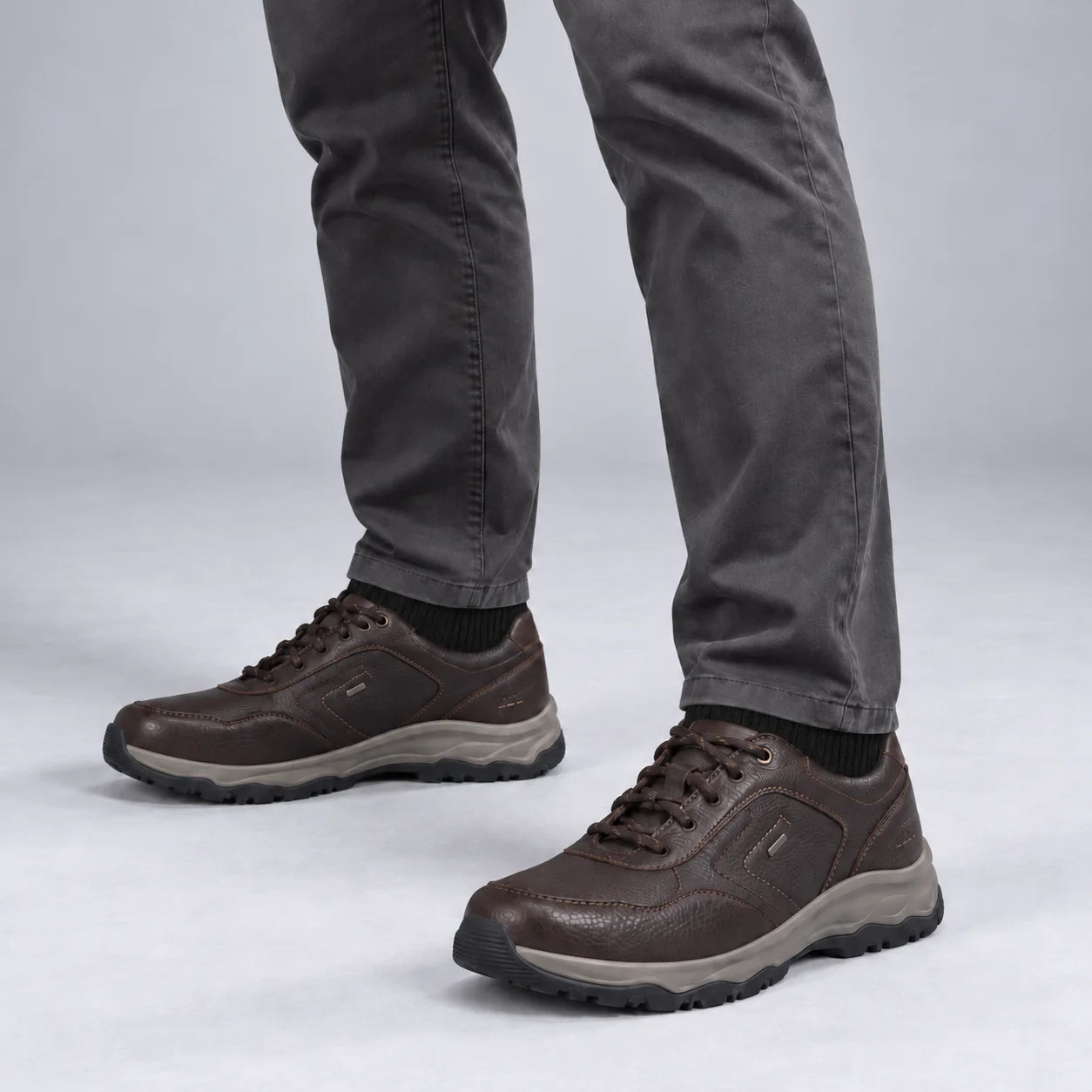 Male model wearing socks and Josef Seibel Leroy 60 in Moro Brown, square studio footwear view