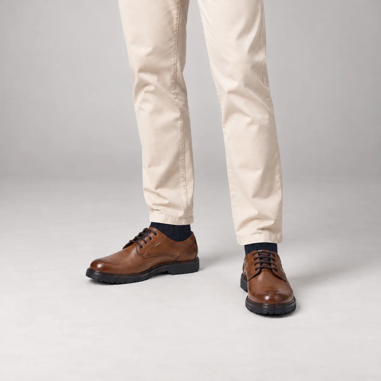 Male model wearing socks and Josef Seibel Erroll 50 in Cognac, square studio footwear view
