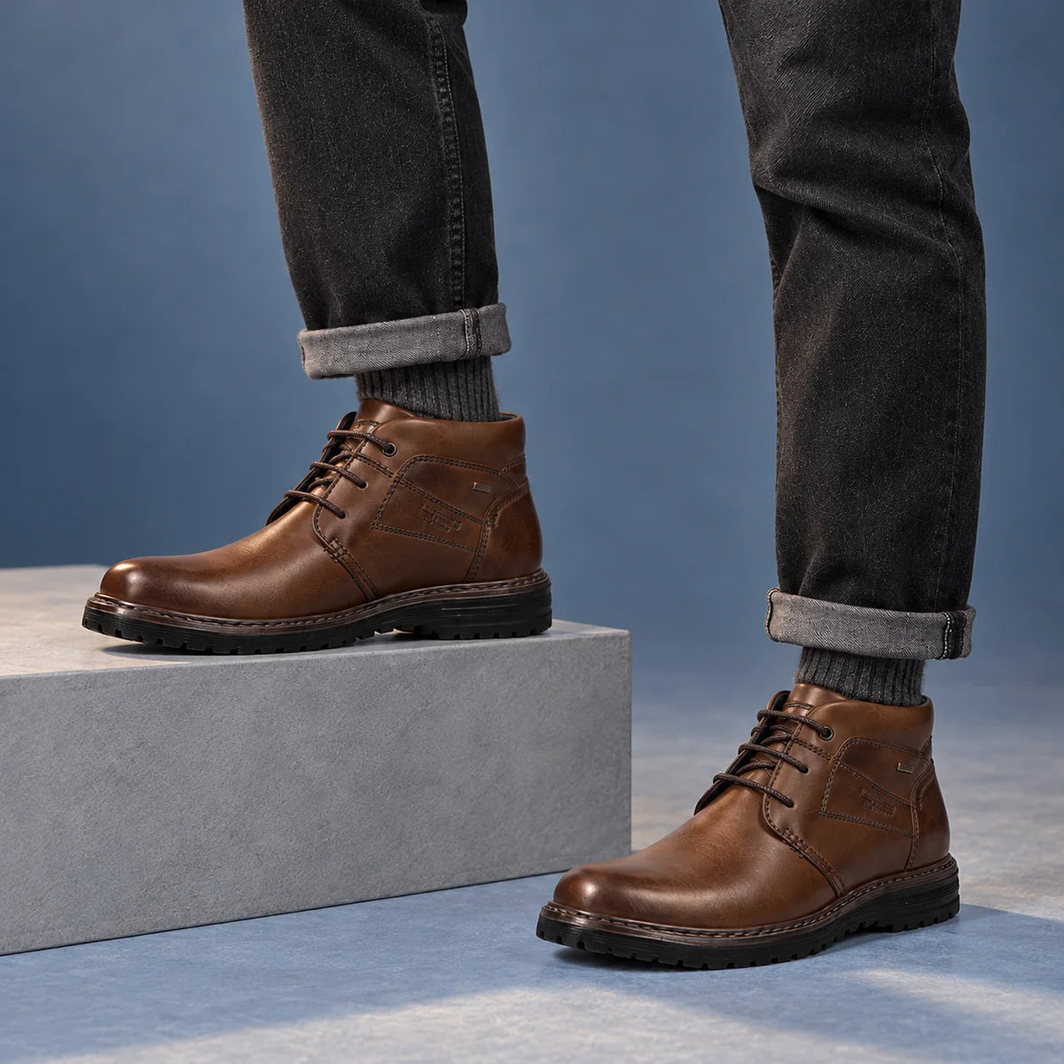 Male model wearing socks and Josef Seibel Erroll 52 in Cognac, square studio footwear view