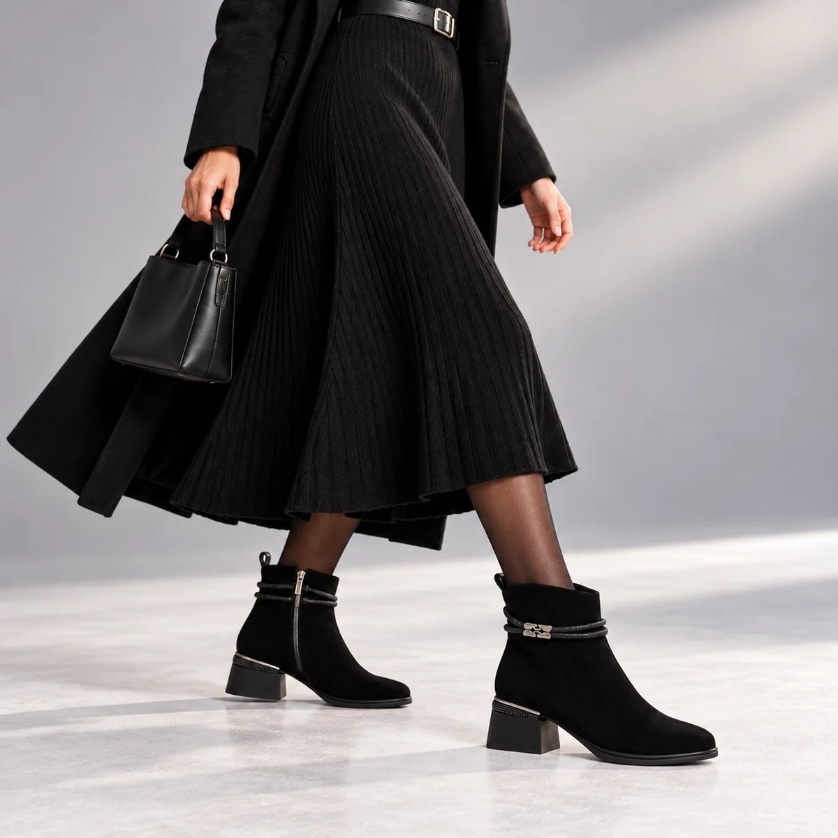 Loretta Vitale black suede embellished ankle boots styled with a long black dress