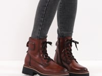 Woman modelling the Tamaris leather brown lace up boot in grey jeans.