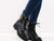 Video showcasing a woman confidently modeling the boots with blue jeans.