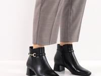 Woman modelling the Tamaris ankle boot with pants.