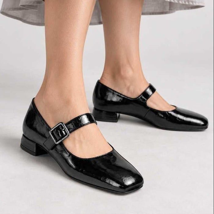 Unisa Culver black patent Mary Jane shoes worn with a grey midi skirt