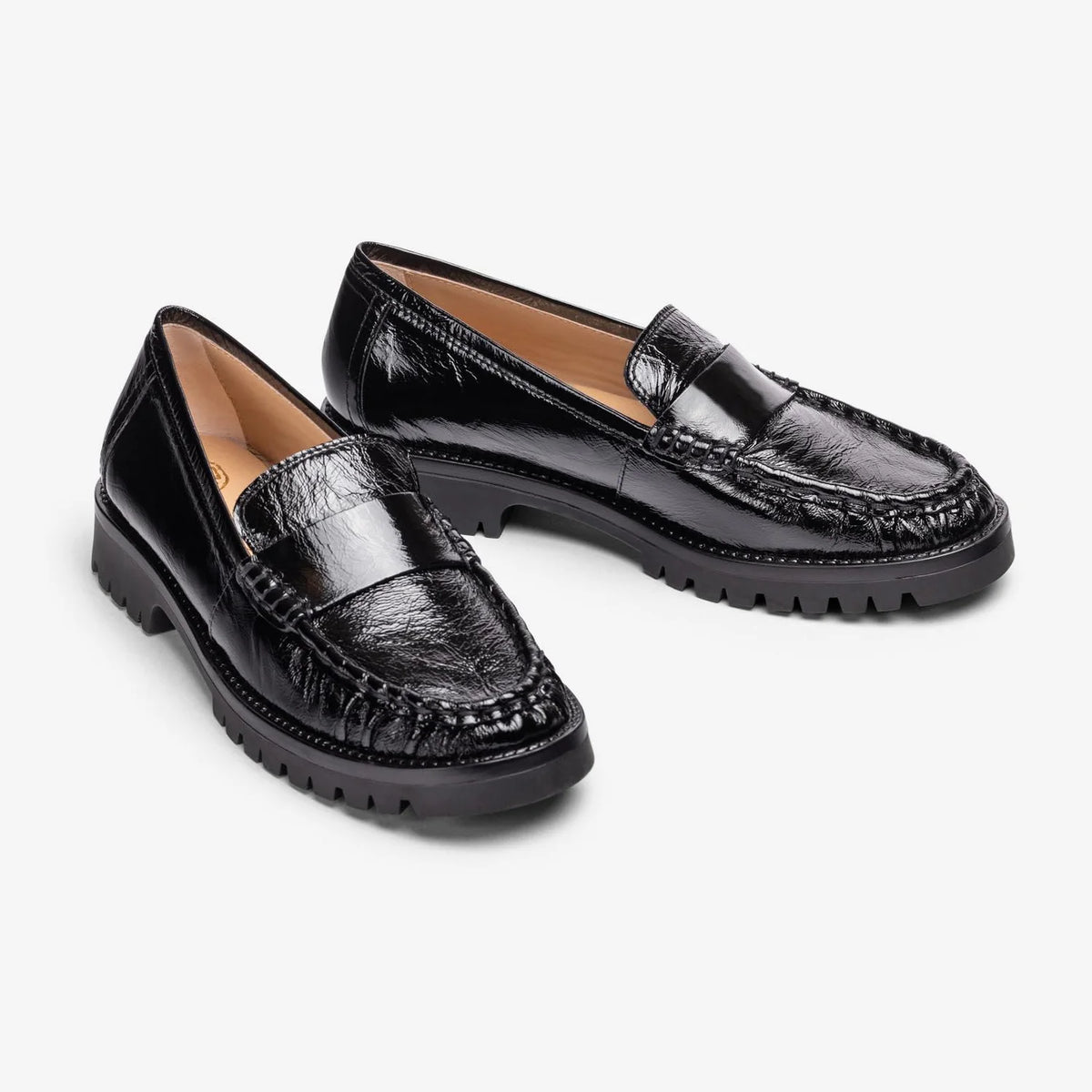 Unisa Fijo black crinkled patent loafers shown as a pair from the front at a three-quarter angle.