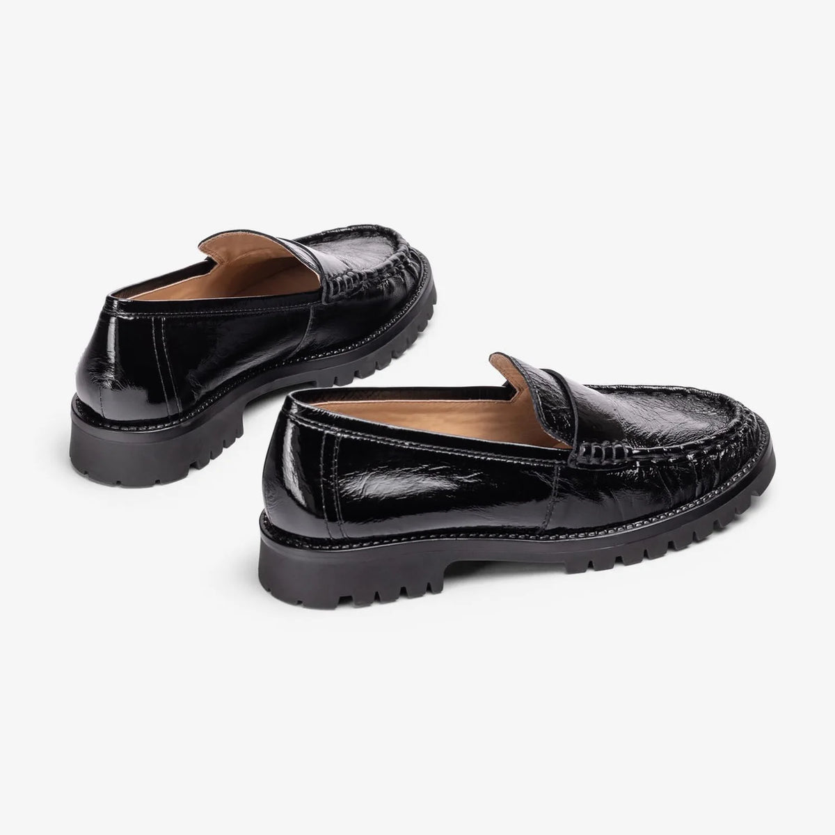 Rear view of Unisa Fijo black patent loafers, showing the low heels and leather lining.