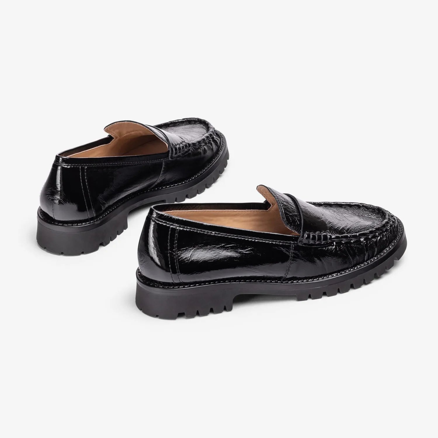 Rear view of Unisa Fijo black patent loafers, showing the low heels and leather lining.
