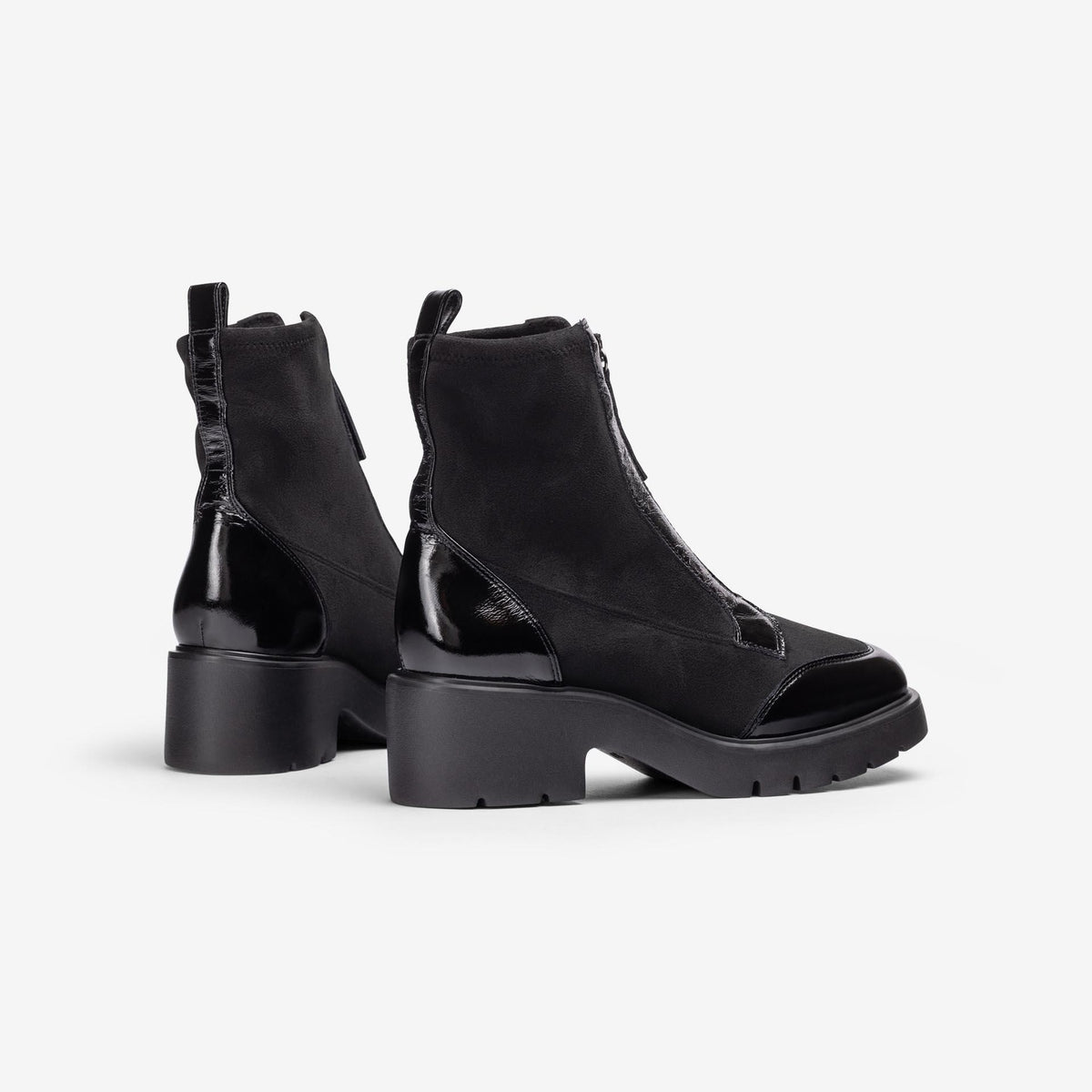 Unisa Jandro black stretch and patent ankle boots showing rear pull tabs, glossy heel panels and treaded soles