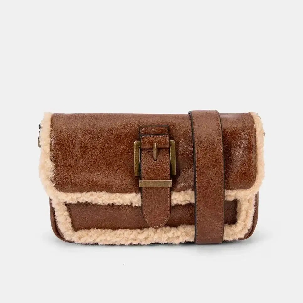 Brown leather bag with beige interior on a white background
