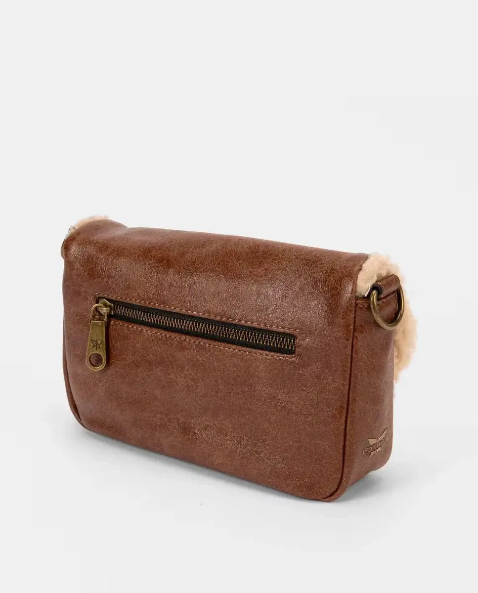 Brown leather crossbody bag with shearling lining on a light gray background