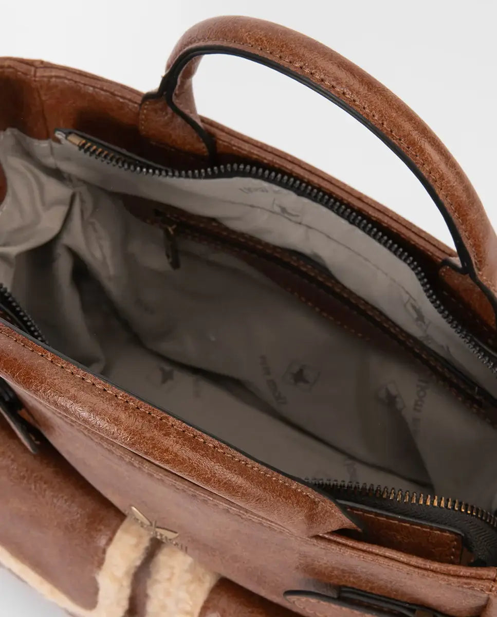 Brown leather bag with a visible brand name on a white background