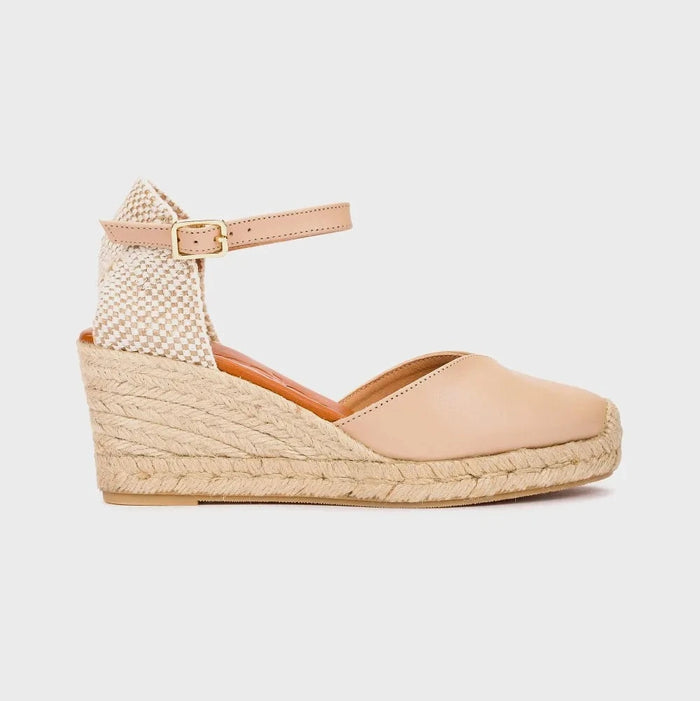 Beige wedge sandal with espadrille sole on a light gray background