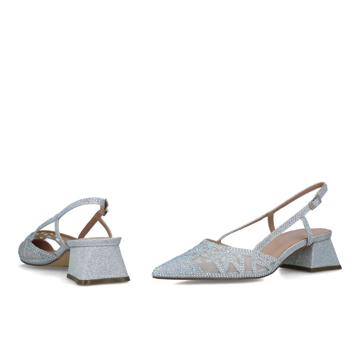 Diagonal perspective of the silver low block heel sandals, highlighting the pointed toe and slingback design.